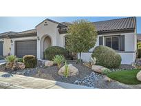 Charming home featuring desert landscaping, including rocks and cacti, plus a gray garage door at 25925 W Mcrae Dr, Buckeye, AZ 85396