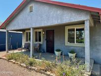 Inviting covered porch with seating and garden bed offers a relaxing outdoor space at 2618 N 15Th St, Phoenix, AZ 85006