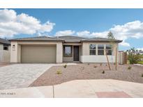 Charming single-story home with a well-manicured desert landscape and paved driveway leading to the two-car garage at 26361 N 76Th Dr, Peoria, AZ 85383