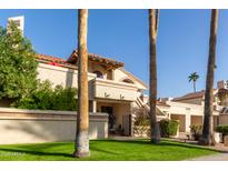 Charming two-story home showcasing a tile roof, desert landscaping, and a private gated entry at 9709 E Mountain View Rd # 2703, Scottsdale, AZ 85258
