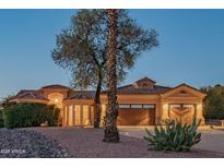 Charming single-Gathering home showcasing a well-manicured desert landscape and a two-car garage at 11018 N Regency Pl, Fountain Hills, AZ 85268