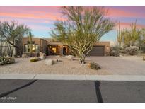 Charming desert home with drought-resistant landscaping, a two-car garage, and a picturesque Arizona sunset at 11082 E Mark Ln, Scottsdale, AZ 85262