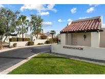 Charming community entrance featuring lush landscaping and classic Santa Fe architecture at 1221 E Palacio Dr, Phoenix, AZ 85014