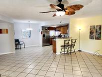 Bright living room with tile floors, ceiling fan, and breakfast bar to the kitchen at 16402 N 31St St # 134, Phoenix, AZ 85032