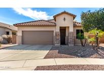 Charming single-story home with a well-maintained yard and a two-car garage at 17063 W Nottingham Way, Surprise, AZ 85374