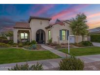 Charming stucco home featuring manicured lawn, beautiful landscaping, and decorative wrought iron accents at 20618 W Western Dr, Buckeye, AZ 85396