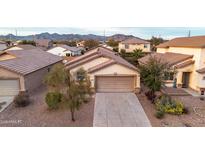 Charming single-story home featuring a two-car garage and desert landscaping at 22756 W Papago St, Buckeye, AZ 85326