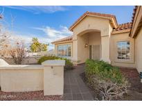 Inviting front entrance featuring an arched entryway, tiled walkway, and well-maintained desert landscaping at 2365 E Shea Blvd, Phoenix, AZ 85028