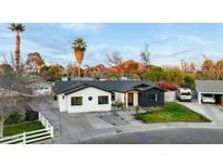 Beautifully renovated ranch home featuring modern two-tone exterior and landscaped front yard with mountain views at 3640 E Fairmount Ave, Phoenix, AZ 85018