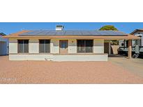 Charming single-story home featuring solar panels and a well-maintained rock front yard at 414 W Piute Ave, Phoenix, AZ 85027