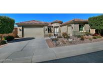 Charming home featuring desert landscaping, tile roof, and a spacious driveway leading to a two-car garage at 4182 N Potomac Dr, Florence, AZ 85132