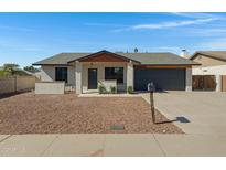 Charming single-story home featuring desert landscaping, a two-car garage, and a welcoming front entry at 5242 S Clark Dr, Tempe, AZ 85283