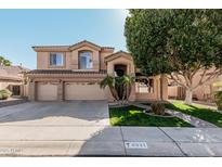 Charming two-story home with a three car garage, desert landscaping, and tiled roof details at 6931 W Antelope Dr, Peoria, AZ 85383