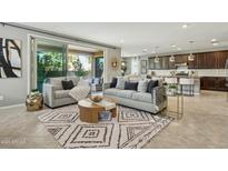 Open living room with neutral colors, stylish furnishings and a seamless flow to the outdoor living space at 8516 W Peppertree Ln, Glendale, AZ 85305