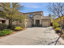 Charming home with a three-car garage, concrete driveway and well-maintained landscaping at 18053 W Rimrock St, Surprise, AZ 85388