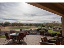 Inviting covered patio offers stunning golf course views, perfect for outdoor dining and relaxation at 19839 N 267Th Ave, Buckeye, AZ 85396