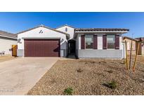 Charming single-story home featuring a two-car garage and low-maintenance desert landscaping at 26007 N 160Th Ln, Surprise, AZ 85387