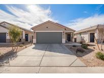 Charming single-story home with neutral stucco, desert landscaping, and a spacious two-car garage at 35421 W San Alvarez Ave, Maricopa, AZ 85138