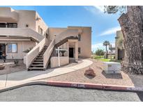 Multi-level condo featuring well-maintained landscaping, walkways, and convenient access to various levels at 7061 E Broadway Rd # 48, Mesa, AZ 85208