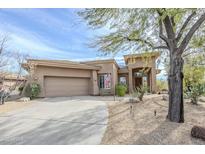 Inviting single story home with mature trees, desert landscaping and a convenient two car garage at 7321 E Crimson Sky Trl, Scottsdale, AZ 85266