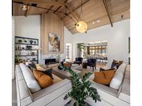 Stunning living room featuring a vaulted ceiling, fireplace, modern furnishings, and a stylish open-concept design at 7508 E Laredo Ln, Scottsdale, AZ 85250