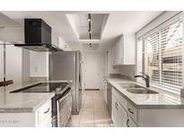 Bright kitchen featuring granite countertops, stainless steel appliances, and modern fixtures at 8841 S 48Th St # 1, Phoenix, AZ 85044