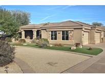 Stunning single-story home with stone accents, lush landscaping, and a circular driveway at 10236 W Westwind Dr, Peoria, AZ 85383