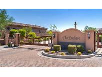 Gated community entrance with desert landscaping, a decorative stone wall, and updated gate lighting at 13044 N Northstar Dr, Fountain Hills, AZ 85268