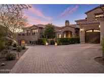 Stunning stone home featuring a large brick driveway and lush landscaping at 13808 S Canyon Dr, Phoenix, AZ 85048