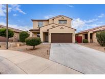 Charming two-story home featuring a desert landscape, brown garage door and a classic design at 16789 W Moreland St, Goodyear, AZ 85338