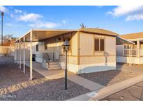 Charming manufactured home featuring covered parking, quaint exterior, and well-maintained landscaping at 535 S Alma School Rd # 60, Mesa, AZ 85210