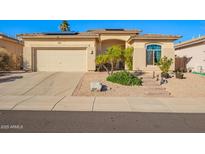 Charming single-story home featuring a desert landscape, solar panels, and a neutral-toned facade at 6442 W Cavedale Dr, Phoenix, AZ 85083