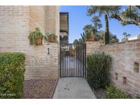 Charming gated entrance to home, with brick accents and desert landscaping at 7401 E Northland Dr # 1, Scottsdale, AZ 85251