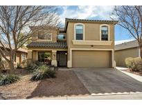 Charming two-story home featuring a two-car garage and low maintenance landscaping at 77 W Diamond Trl, San Tan Valley, AZ 85143