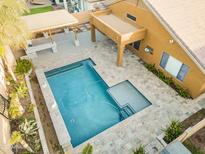 Aerial shot showcases a refreshing pool with tanning deck and a covered patio area at 8630 W Apache St, Tolleson, AZ 85353