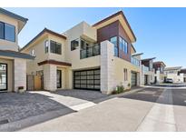 Contemporary two-story home with desert landscaping, private patios, and modern garage doors at 1 Easy St # 15, Carefree, AZ 85377