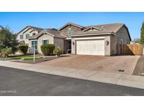 Charming single-story home features stone accents, a two-car garage, and well-maintained landscaping at 9388 W Cashman Dr, Peoria, AZ 85383