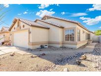 Charming single-story home with a two-car garage and desert landscaping in a sunny neighborhood at 10622 W Mohawk Ln, Peoria, AZ 85382