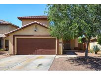 Charming two-story home featuring a brown garage door, desert landscaping, and a welcoming front entrance at 12054 W Aster W Dr, El Mirage, AZ 85335