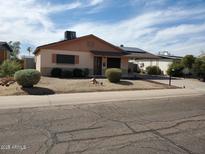 Cozy single-story home with a desert-style front yard, rock landscaping, and covered parking at 15436 N 23 St, Phoenix, AZ 85022