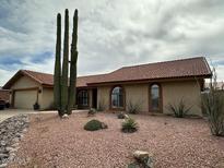Charming home with a desert landscape, red tile roof, and arched windows at 15445 E Thistle Dr, Fountain Hills, AZ 85268