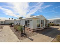Charming single-story home featuring a well-maintained yard and appealing curb appeal under a partly cloudy sky at 17200 W Bell Rd # 2162, Surprise, AZ 85374
