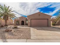 Exterior of a single-story home featuring a desert landscape, a two car garage, and a tile roof at 17815 W Calistoga Dr, Surprise, AZ 85387