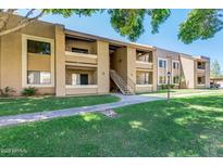 Attractive two-story condo building with well-maintained landscaping and walkways at 2146 W Isabella Ave # 215, Mesa, AZ 85202