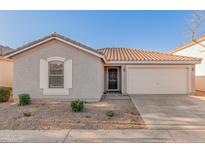 Charming single-story home featuring a well-maintained yard and a spacious two-car garage at 665 E Winchester Way, Chandler, AZ 85286