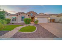 Charming single-Gathering home with a well-manicured front yard, beautiful stone accents, and a spacious two-car garage at 9388 W Cashman Dr, Peoria, AZ 85383