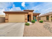 Charming single-story home with a well-maintained front yard and a two-car garage at 18474 N Celis St, Maricopa, AZ 85138