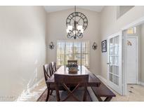 Bright dining room boasts a decorative clock and a rustic wooden table set for a comfortable dining experience at 4502 E Hartford Ave, Phoenix, AZ 85032