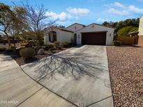 Charming single-story home featuring a well-manicured front yard and a spacious two-car garage at 4806 N 186Th Ln, Goodyear, AZ 85395