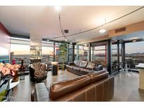Open living room with tile flooring, floor to ceiling windows, and city views at 4808 N 24Th St # 1424, Phoenix, AZ 85016